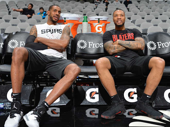 LaMarcus Aldridge #12 of the San Antonio Spurs and Damian Lillard #0 of the Portland Trail Blazers talks before the game on March 16, 2019 at the AT&T Center in San Antonio.
